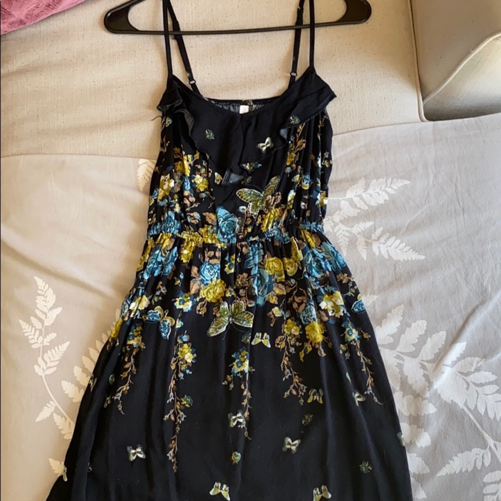 Sleeveless black dress with blue and green